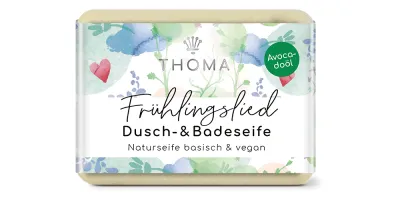 rechteckige, hellgelbe Seife mit blumiger Verpackung und Aufschrift Frühlingslied, Dusch und Badeseife mit Sheabutter und Aloe von der Naturseifen Manufaktur Uckermark.