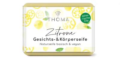rechteckige, gelbliche Seife mit Verpackung und Aufschrift Zitrone, Gesichts und Körperseife mit Sheabutter und Bio Hanföl vegan